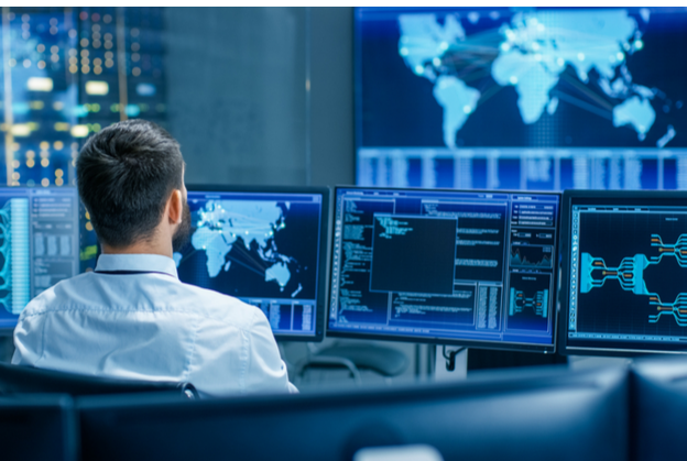 back of man's head sitting in a security operations center