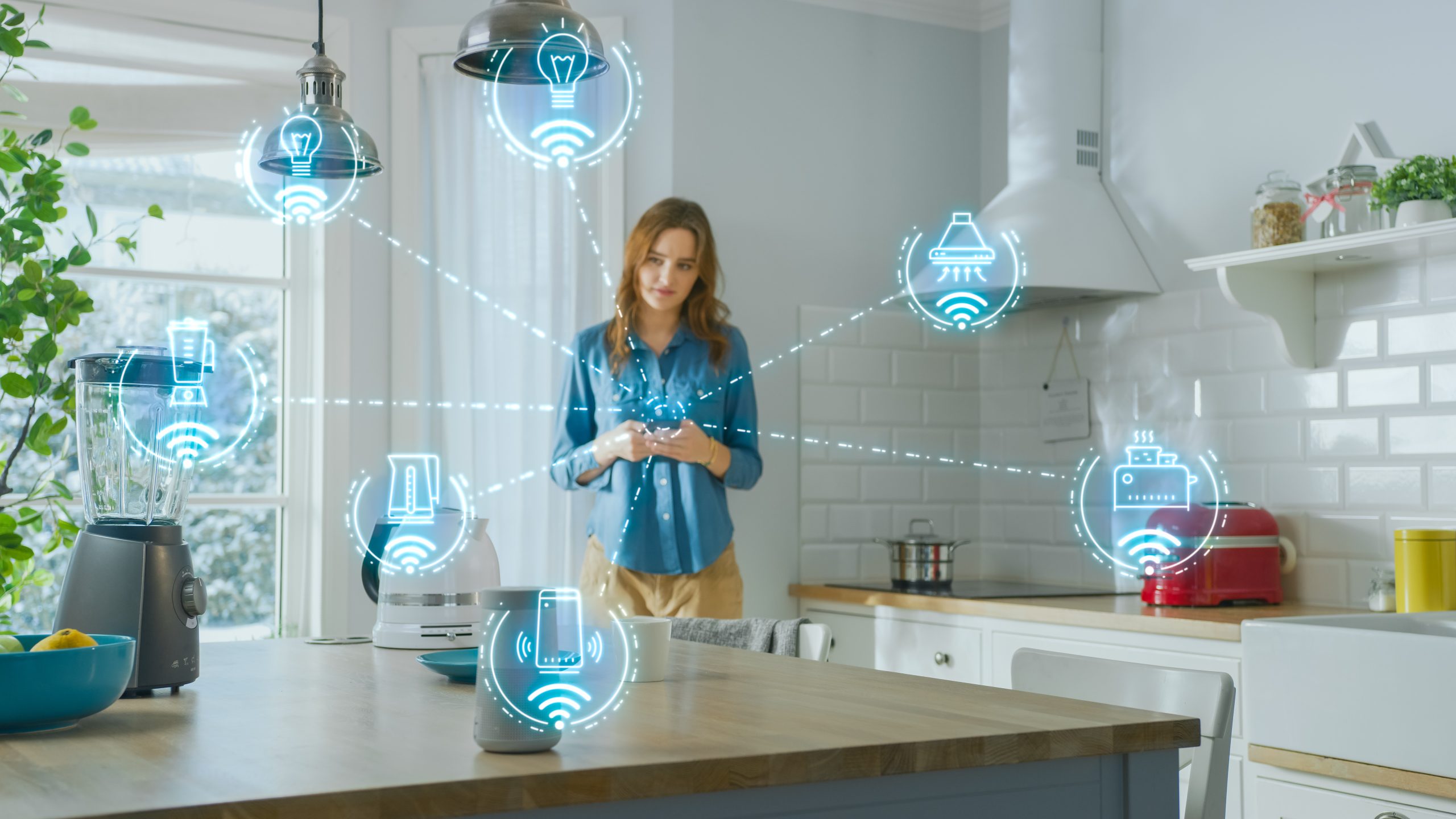 woman in kitchen using IoT controls in her home